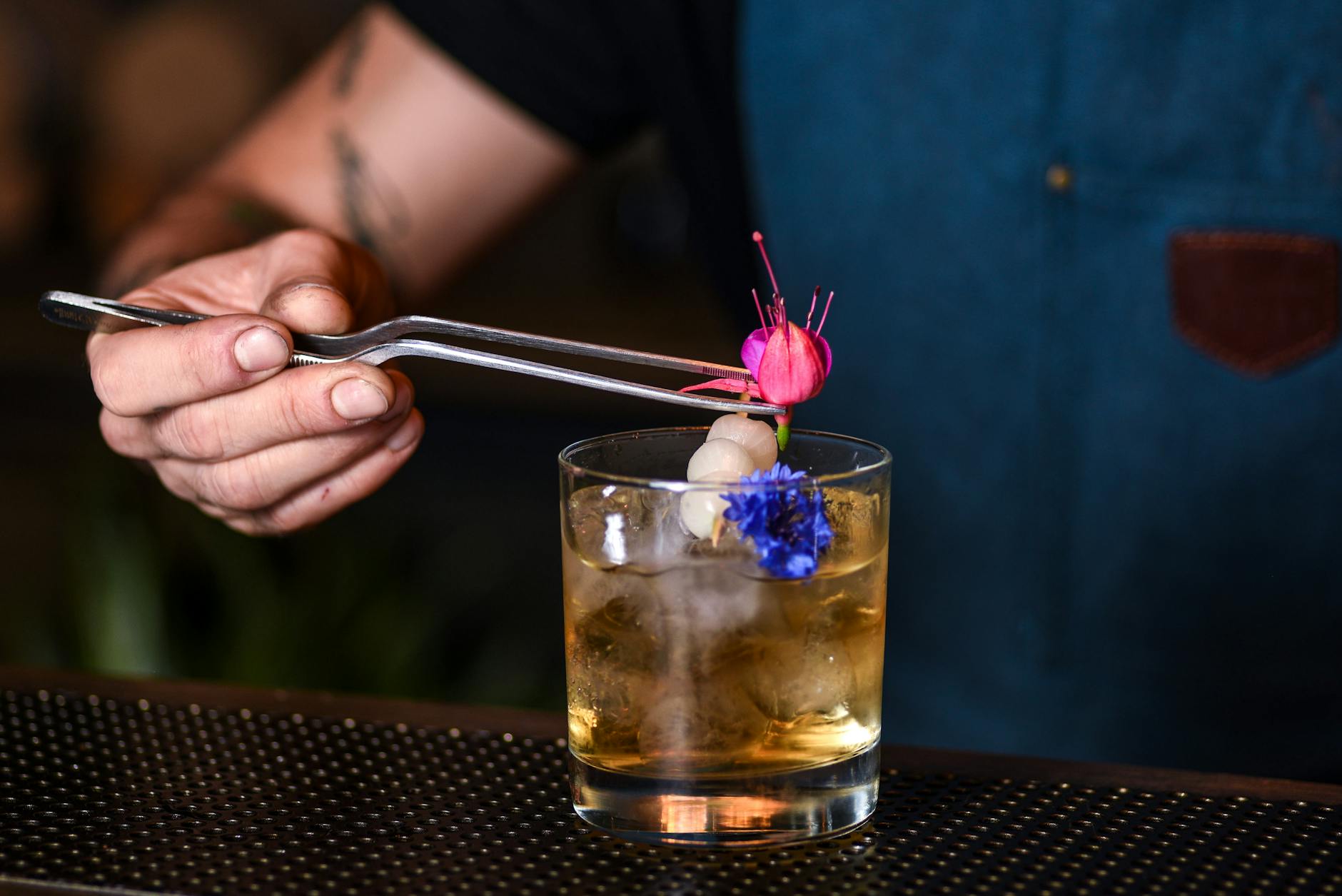 Barman dekoruje koktajl przyprawą w modnym barze w Nowym Jorku